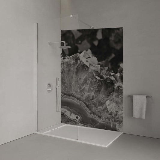 Monochrome amethyst panel in a modern shower, showcasing layered crystalline structure in black and white.