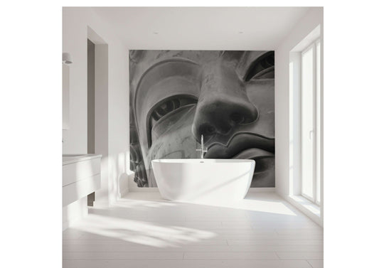 Close-up of a serene Buddha face in a stylish bathroom setting with a modern bathtub.