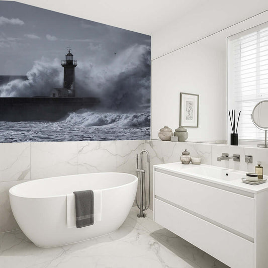 Bathroom with lighthouse and crashing waves mural, featuring moody grey tones and vibrant details.