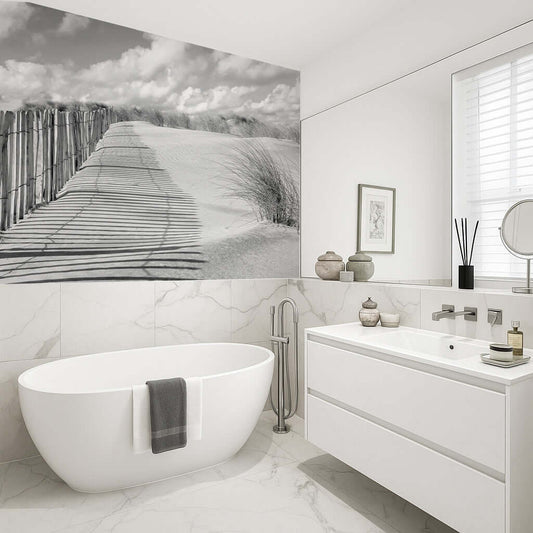 Stylish bathroom featuring a shower panel with a black and white beach scene of dunes and a picket fence.