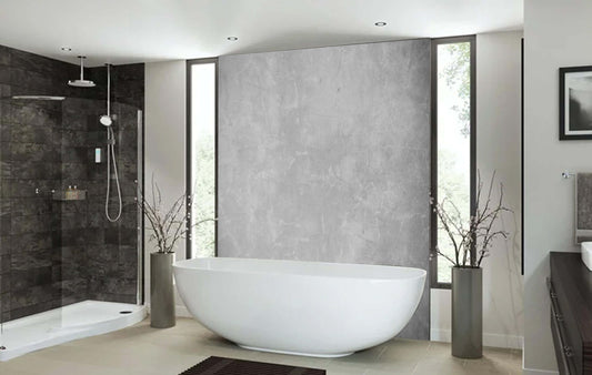 Modern bathroom with grey concrete wall panel, freestanding tub, and stylish decor for an industrial look.