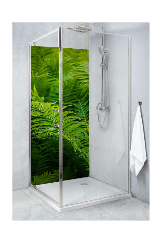 Large green ferns decorate a modern shower panel, adding vibrant natural beauty to the bathroom.