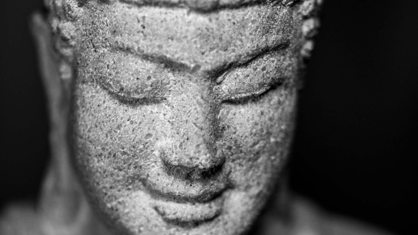 Close-up of a serene Buddha face sculpture, showcasing tranquility and peace for bathroom decor.