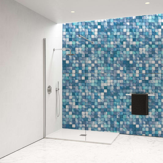 Small pool style mosaic tiles in shades of blue, creating a stunning shower wall design for modern interiors.
