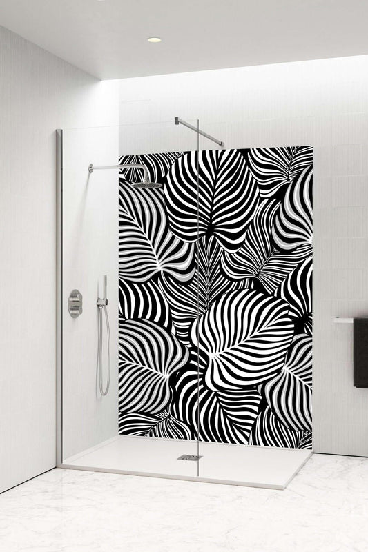 Black and white zebra-style shower panel with botanical leaf design, transforming bathroom into a modern retreat.