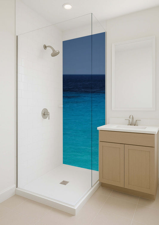 Modern bathroom shower with glass door featuring dark blue ocean mural for a calming atmosphere.