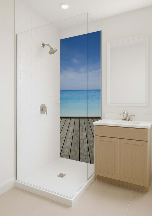 Modern bathroom with a glass shower featuring a serene ocean view and weathered decking backdrop.