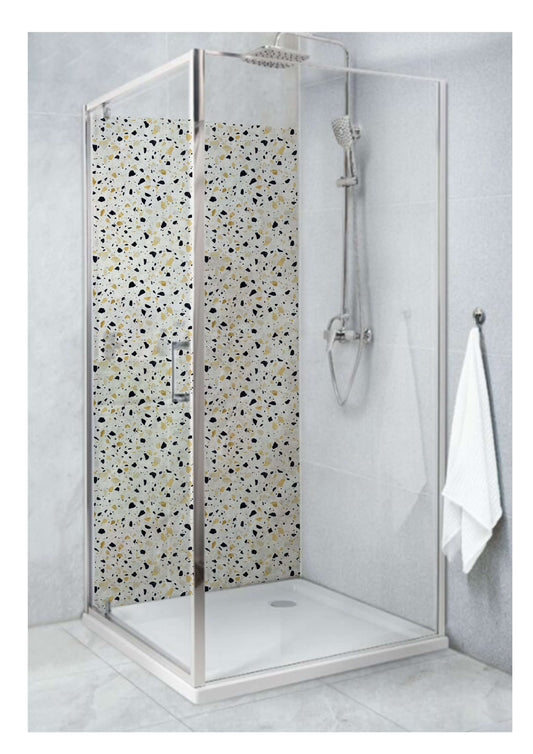 Shower with yellow terrazzo stone style panel, showcasing vibrant patterns in a modern bathroom setting.